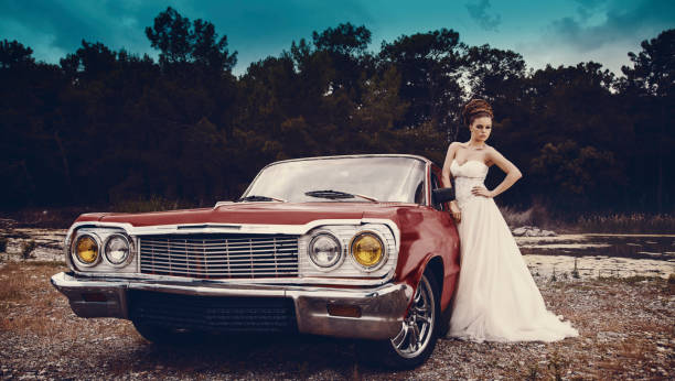 istock beautiful young bride near to classic car. 1256921506