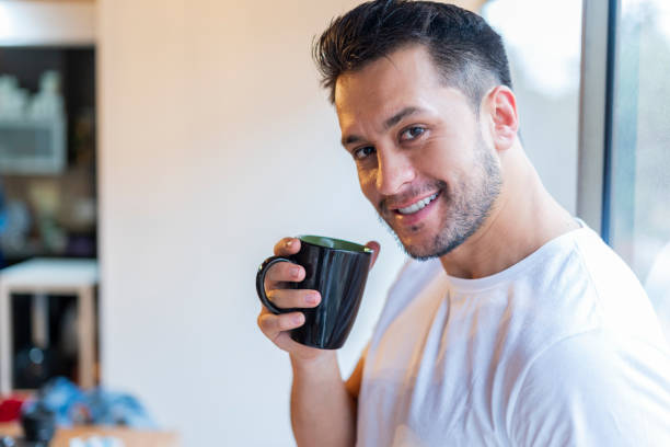 istock Latino man drinks coffee in the morning 1256921701