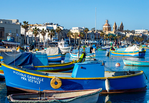 Marsaxlokk, Malta, Feb 28, 2020. Malta Marsaxlokk harbour with colorful fishing boats in a sunny day.