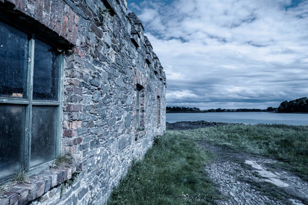 istock Stone built boat shed by the coastline 1256929699