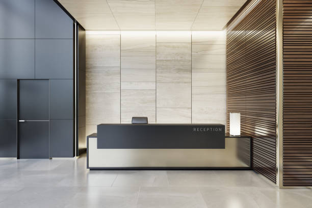 Reception desk luxurious open space interior with marble tiles with copy space Luxurious reception desk interior room with natural stone marble tiles and wood panels decoration.
Copy space on desk and walls.
Stylish interior area with a modern architectural details.
Natural stone floor. Ceiling with strip cove lighting and white spotlights. lobby stock pictures, royalty-free photos & images