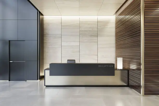 Luxurious reception desk interior room with natural stone marble tiles and wood panels decoration.
Copy space on desk and walls.
Stylish interior area with a modern architectural details.
Natural stone floor. Ceiling with strip cove lighting and white spotlights.