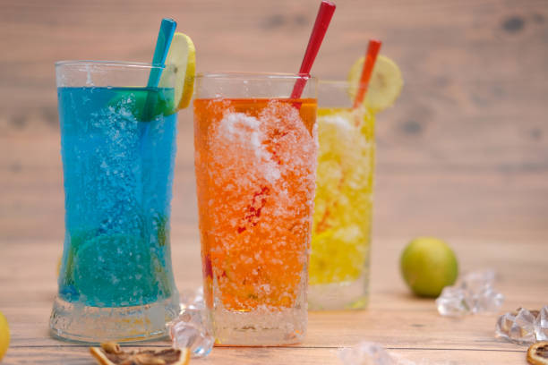 istock Coloful drinks on wooden background 1256938150