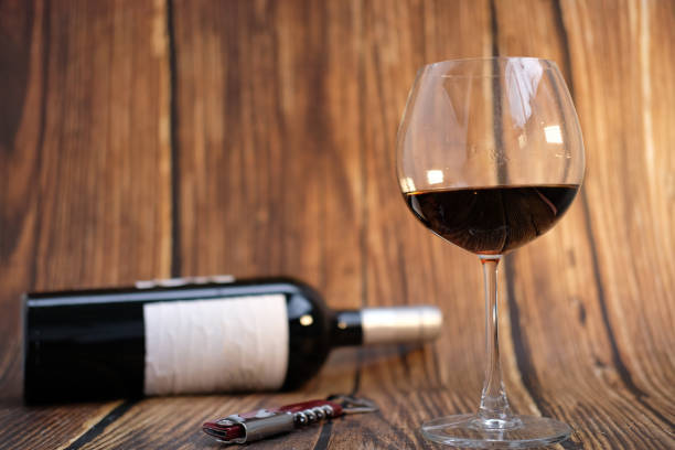 istock Red​ wine glass on wooden background 1256938853