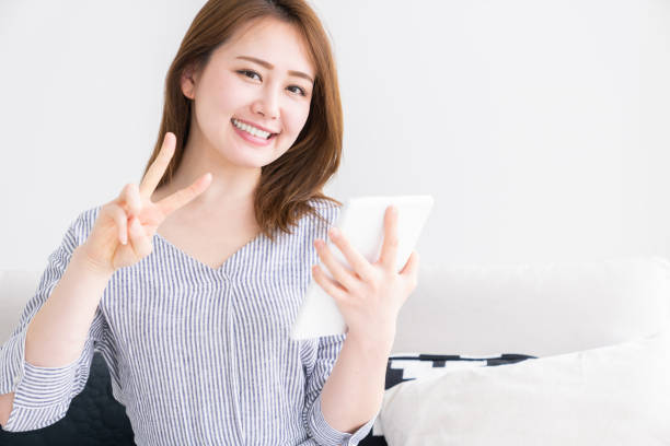 istock asian woman to see a tablet computer 1256940799