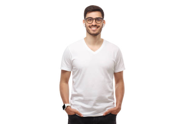 istock Front template of young man standing with hands in pockets, wearing blank tshirt with copy space and glasses, isolated on white background 1256943982