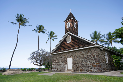 Front view of a wooden Waioli Huiia Church with cloudy sky in the background in Hanalei, Kauai, Hawaii