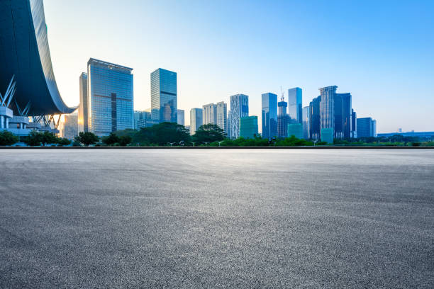 Empty racing track road and modern city buildings in Shenzhen. Empty racing track road and modern city buildings in Shenzhen,China. asphalt stock pictures, royalty-free photos & images