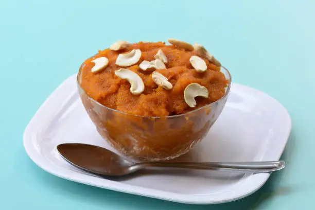 Indian traditional sweet,Plain SemolinaSuji Halwa also known as Sweet Rava Sheera OR Shira - Indian festival sweet garnished with dry fruitsServed in a plate or Bowl,Indian dessert