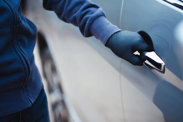 istock The thief tries to get into the car. 1256955770