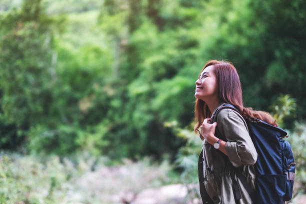 istock traveler with backpack walking  by mountain stream for hiking concept 1256962122