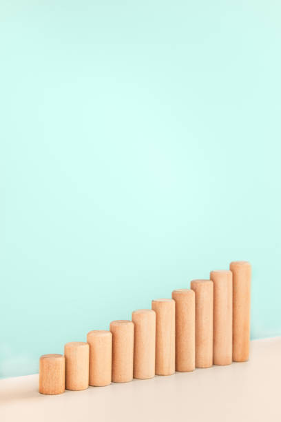 istock Growth bar chart, graph diagram made with wooden block on blue background and copy space. Vertical orientation 1256967192