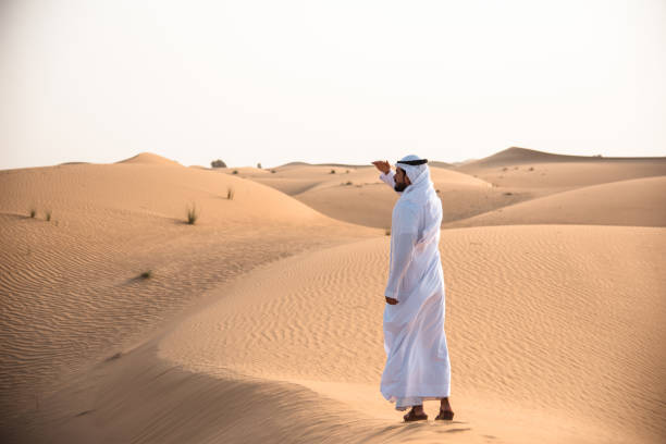istock arabic man walking in the desert 1256967323