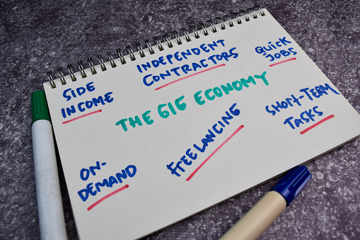 The Gig Economy text with keywords on a book. Chart or mechanism concept.