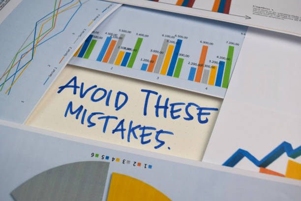 istock Avoid These Mistakes write on a book isolated on Office Desk. Stock market concept 1256967888