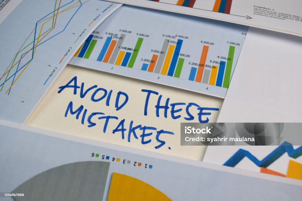 Avoid These Mistakes write on a book isolated on Office Desk. Stock market concept Mistake Stock Photo
