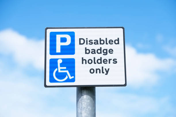 istock Disabled blue badge holder parking sign for driver 1256969728