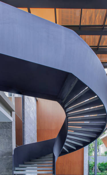 istock Side view of a spiral staircase pattern. Spiral stairs circle in courtyard architecture. Outdoor ladder decoration interior. 1256969857