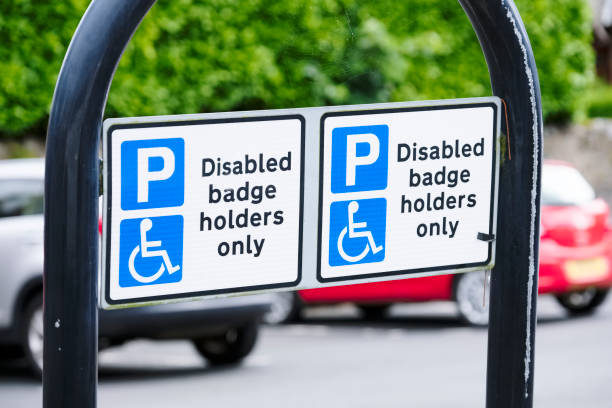 istock Disabled blue badge holder parking sign for driver 1256970588