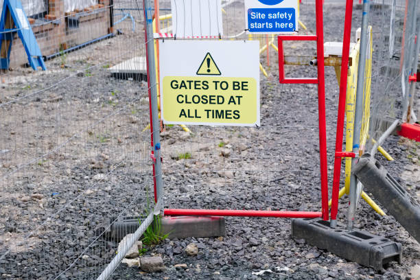 istock Gate must be locked at all times security sign at construction site 1256971670