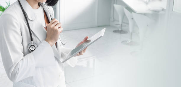 istock Doctor in white background stethoscope tablet in hospital 1256972476