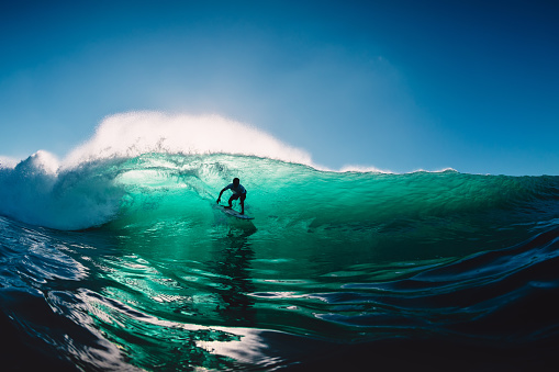 July 12, 2020. Bali, Indonesia. Surfer ride on surfboard at barrel wave. Surfing at Padang Padang
