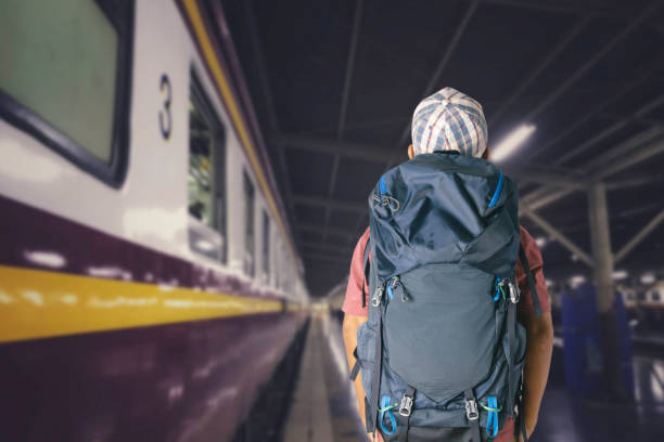 Young man traveler with backpack in the railway, Travel concept.