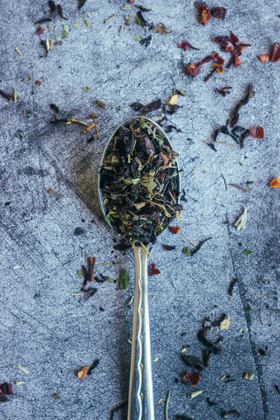 istock Herbal tea in spoon. Spoon with dry tea leaves 1256979056