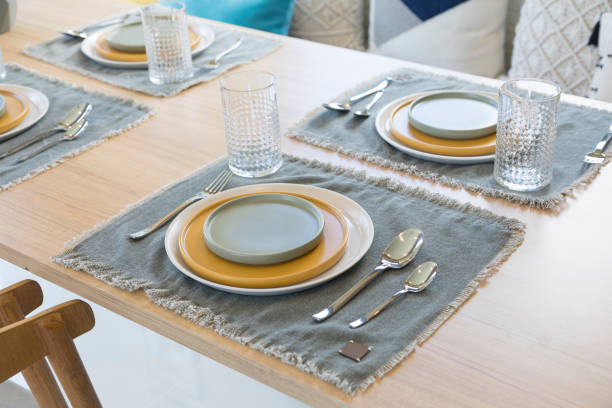 istock Table setting with yellow plate in modern style dining room at home. 1256980253