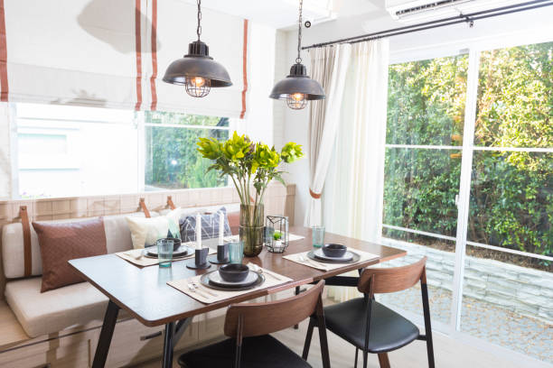 istock Modern loft dinning room with plate setting and hanging lamp 1256980438