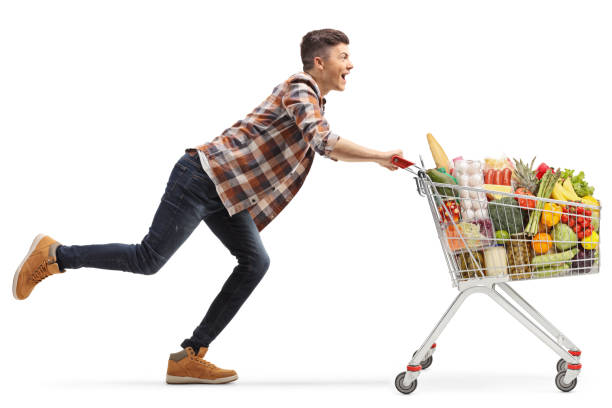 istock Happy young man running with a full shopping cart 1256981990