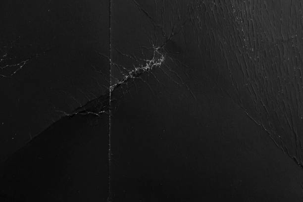 istock Old black paper with creases and scratches 1256982160