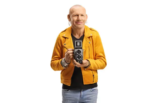 Bald man holding an old fashioned camera recorder isolated on white background
