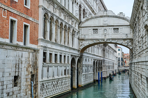 Venice, Italy - November 23, 2019: tourists on gondolas tour below the The Bridge of Sighs. Rio del Palazzo.