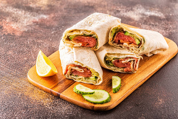 istock Wrapped sandwich with salmon, lettuce, cucumber and cream cheese, selective focus 1256985343