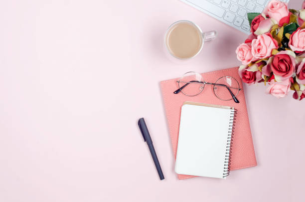 istock desktop with blank notebooks, pens, glasses and coffee 1256986549