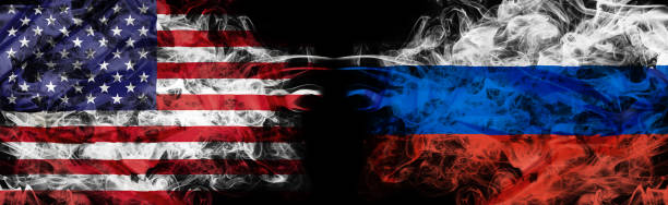 United States and Russia crisis with smoky flags stock photo