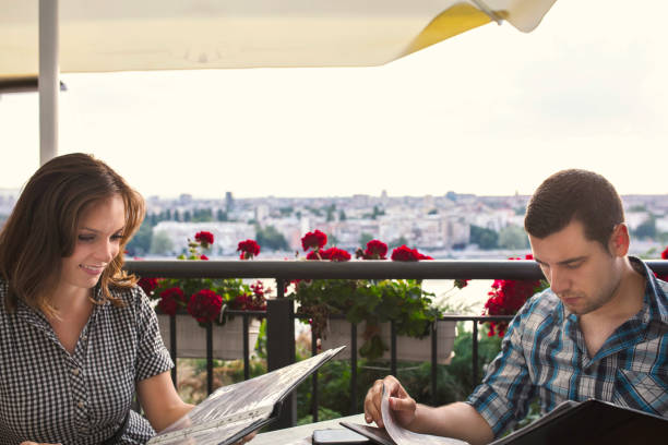 istock Young couple in bar on terrace 1256988883