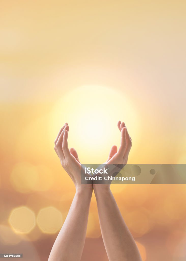 Mind and soul mantra yoga meditation, spiritual mental health practice with woman pose peaceful relaxation training with sunset golden hour summer june solstice sun and sky can candle light bokeh Summer Solstice Stock Photo