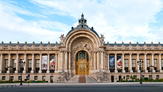 The Petit Palais built for the world exposition in 1900, it now houses the City of Paris Museum of Fine Arts (near Champs Elysees and Invalides Quarter). The beautiful golden door is closed and the street is empty during epidemic Covid19 virus in France. Picture 16/9. Paris in France. June 15, 2020