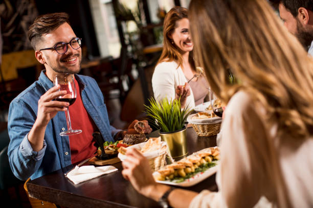 istock Group of young people having dinner in the restaurant 1256990627