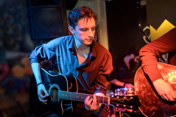 istock Guitar players performing on stage 1256992394