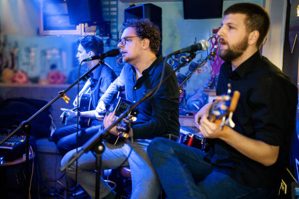 istock Guitar players performing on stage 1256992402