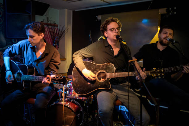 istock Guitar players performing on stage 1256992403