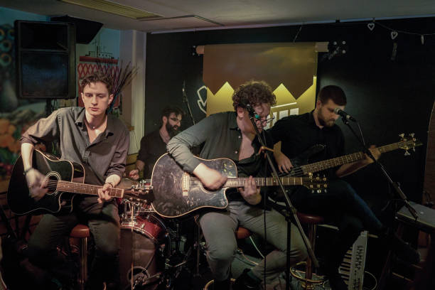 istock Guitar players performing on stage 1256992452