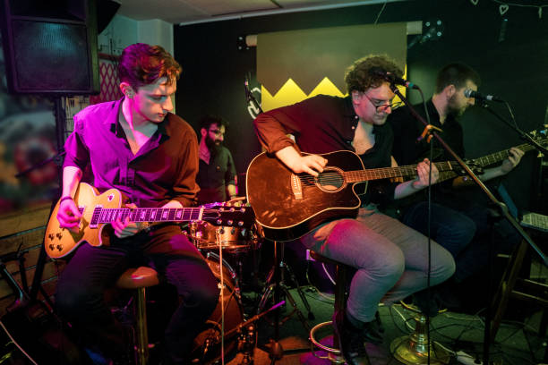 istock Guitar players performing on stage 1256992477