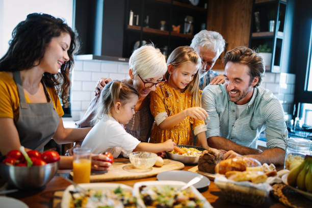 istock Cheerful family spending good time together while cooking in kitchen 1256992969