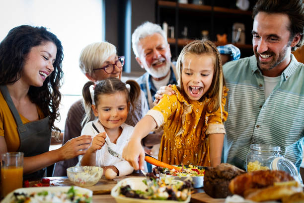 istock Cheerful family spending good time together while cooking in kitchen 1256992982