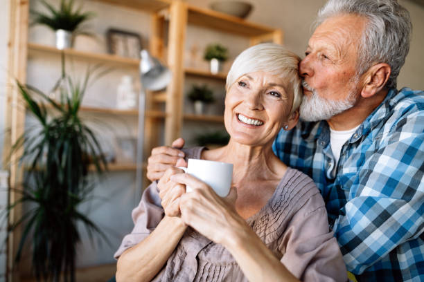 istock Mature couple hugging and relaxing at home together 1256993014