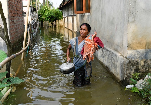 People in a flooded area, due to monsoon rains, in a flood affected village in Morigaon district of Assam on 13 July 2020.